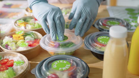 Applying-Eco-Food-Sticker-on-Container-with-Healthy-Meal
